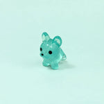 Miniature Glow Mini Dogs Assorted (1pc) displayed on a mint green background