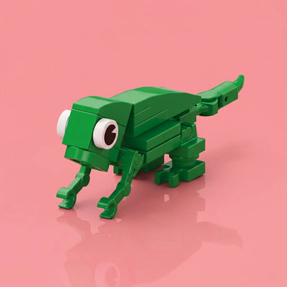 Green toy lizard made of interlocking bricks on a pink background