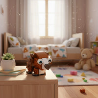 Toy figure on a table in a child's bedroom with a teddy bear and toys in the background.
