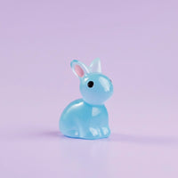 Miniature Glow Rabbit(1pc) on purple background.