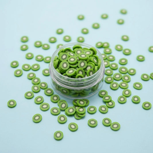 Miniature Polymer Clay Kiwi on light blue background.