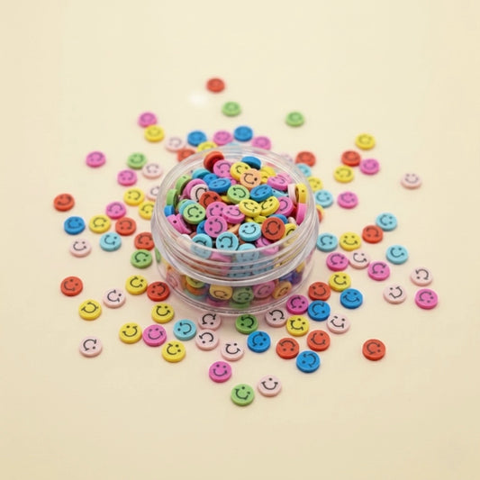 Miniature Polymer Clay Smiley (10pcs) on the pink background.