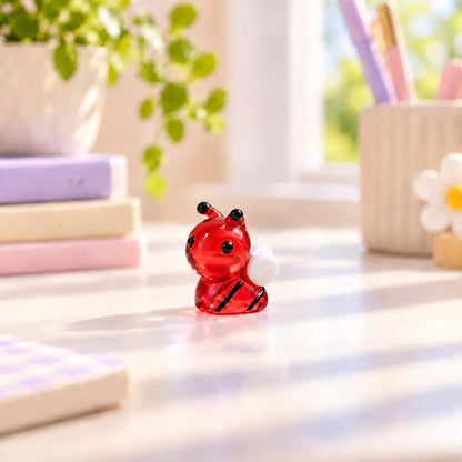 Miniature Glow Bee Assorted (1pc) displayed on a desk near a window
