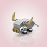 Toy Buffalo figure with gray body, gold horns, and black wheels on a light pink background