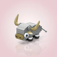 Toy Buffalo figure with gray body, gold horns, and black wheels on a light pink background