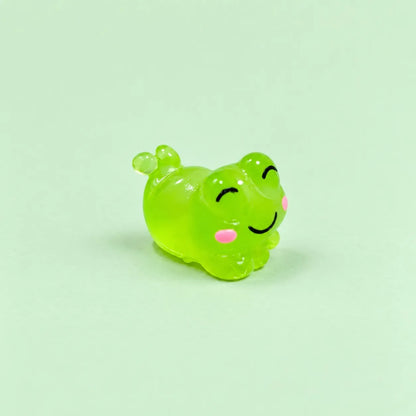 Miniature Glow Cute Resin Frog Assorted (1pc) displayed on a mint green background