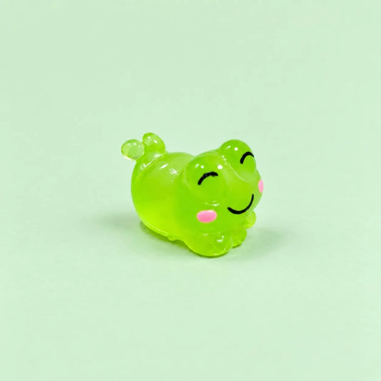 Miniature Glow Cute Resin Frog Assorted (1pc) displayed on a mint green background