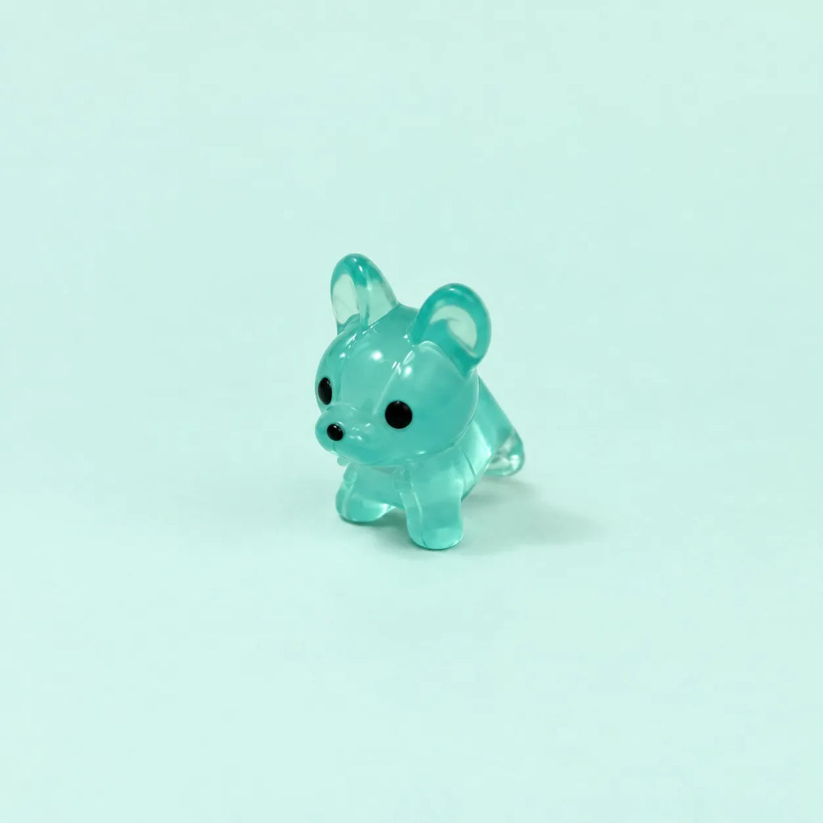 Miniature Glow Mini Dogs Assorted (1pc) displayed on a mint green background