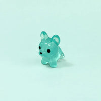 Miniature Glow Mini Dogs Assorted (1pc) displayed on a mint green background