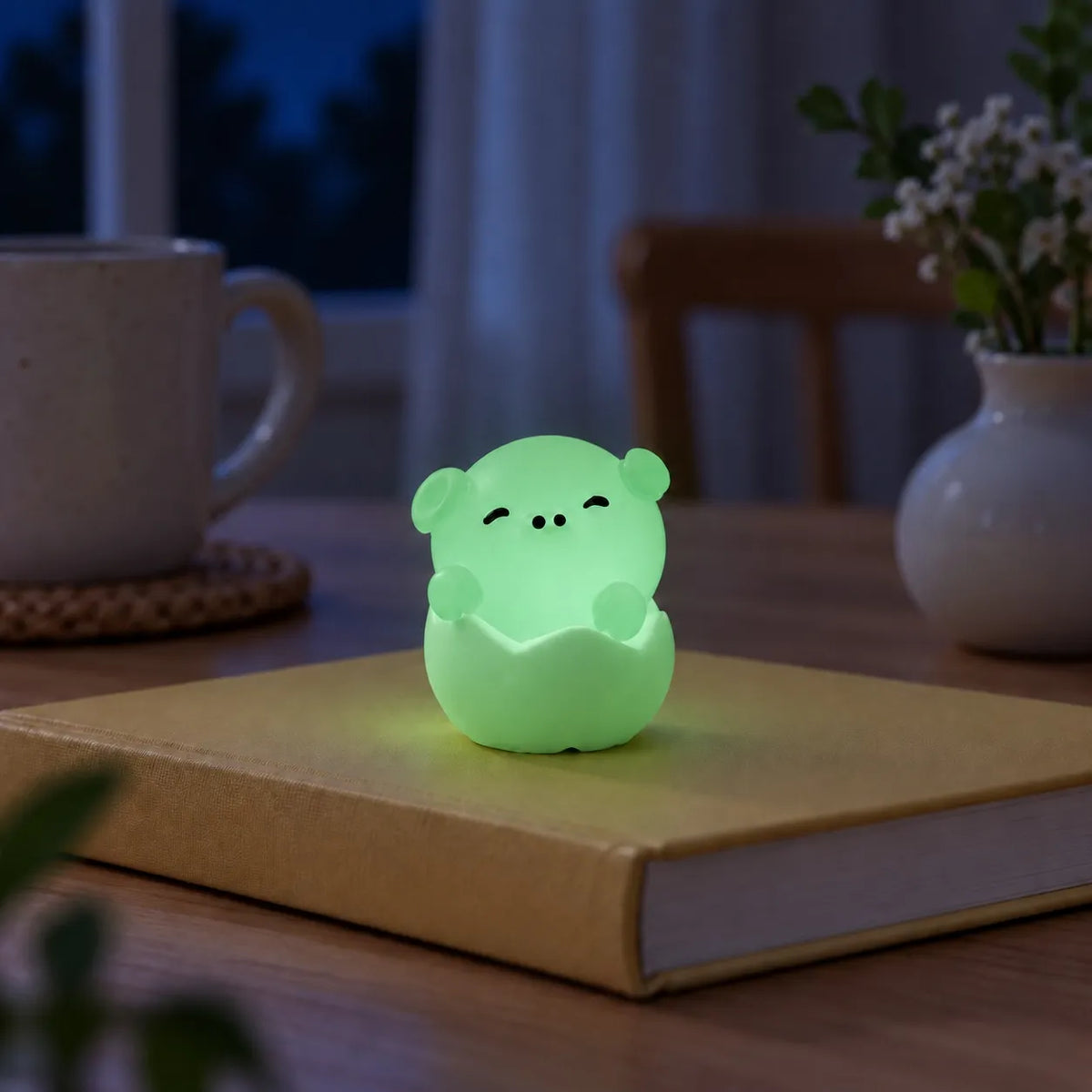 Miniature Glow Eggshell Animal Assorted (1pc) glowing in green on study table.
