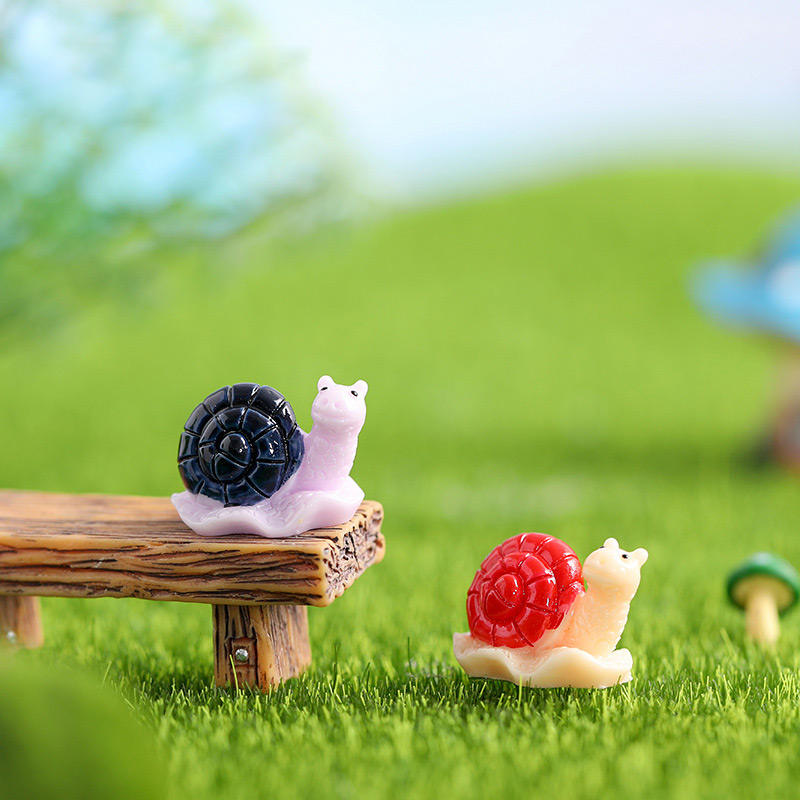 Miniature Snails for Fairy Gardens figures in a garden theme.