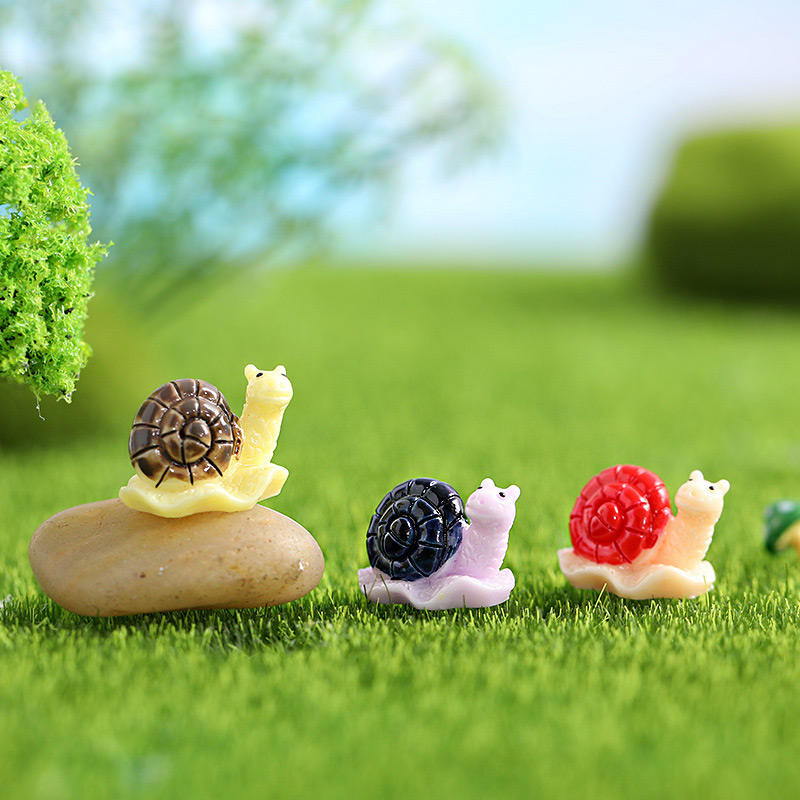 Miniature Snails for Fairy Gardens figures on the green grass.