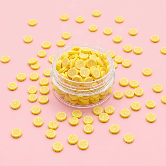 Miniature Polymer Clay Lemon (10pcs) displayed on a light pink background