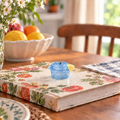 Miniature Glow Mini Cooker Assorted (1pc) displayed on a table with decorative items and fruit bowl