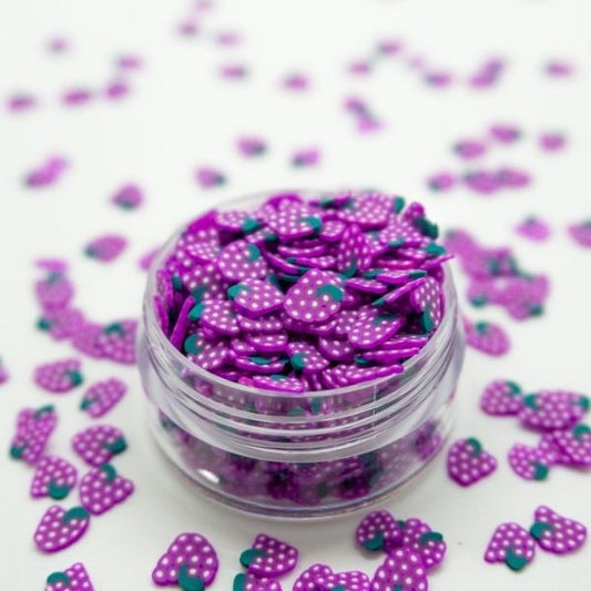 A beautiful Miniature Polymer Clay Grapes in a small glass container with similar several Miniature Polymer Clay Grapes on the floor.