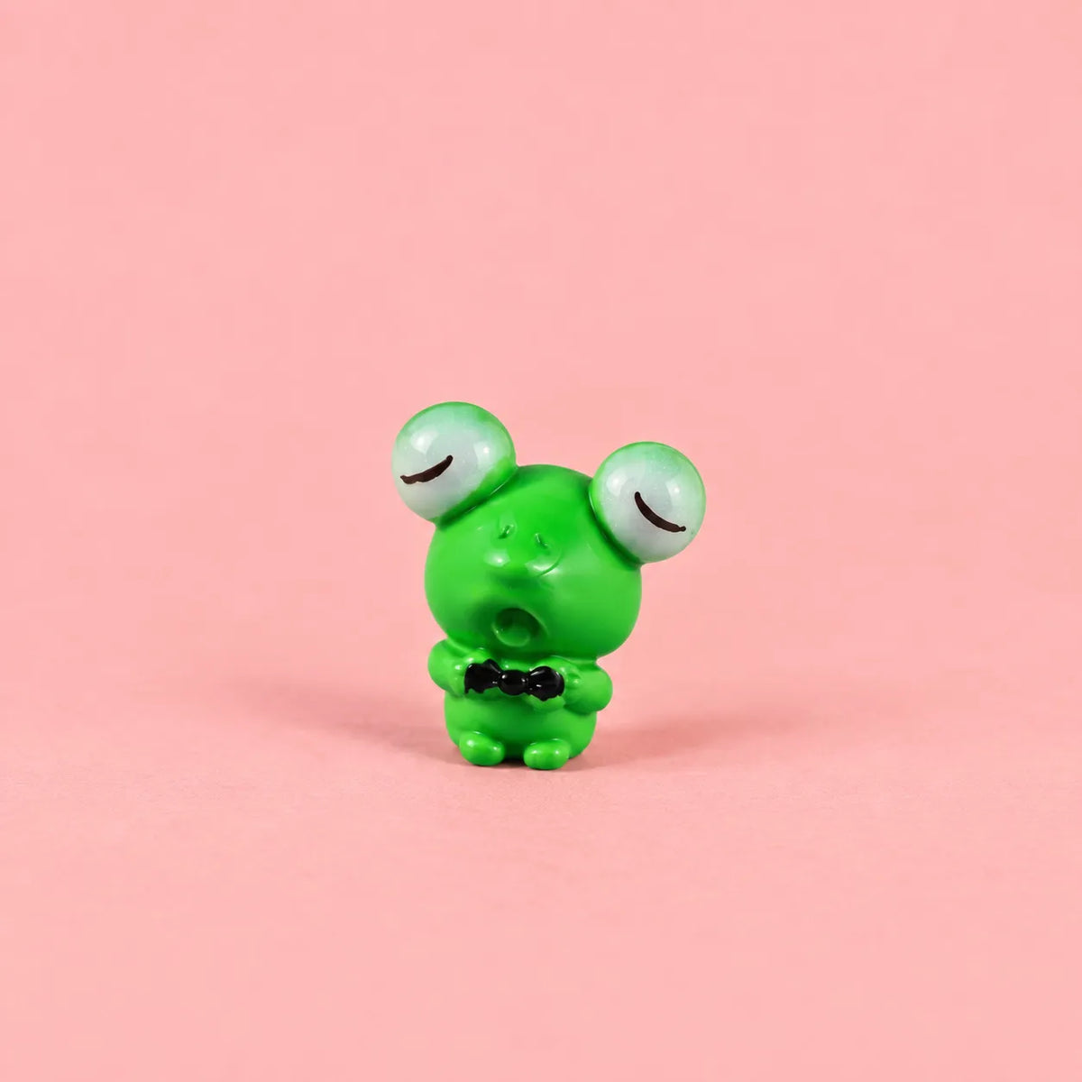 Miniature Resin Mini Frog Assorted (1pc) displayed on a pink background