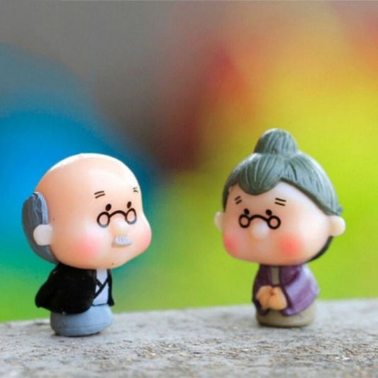 A cute Miniature Old Couple Grandparents kept on a rock.