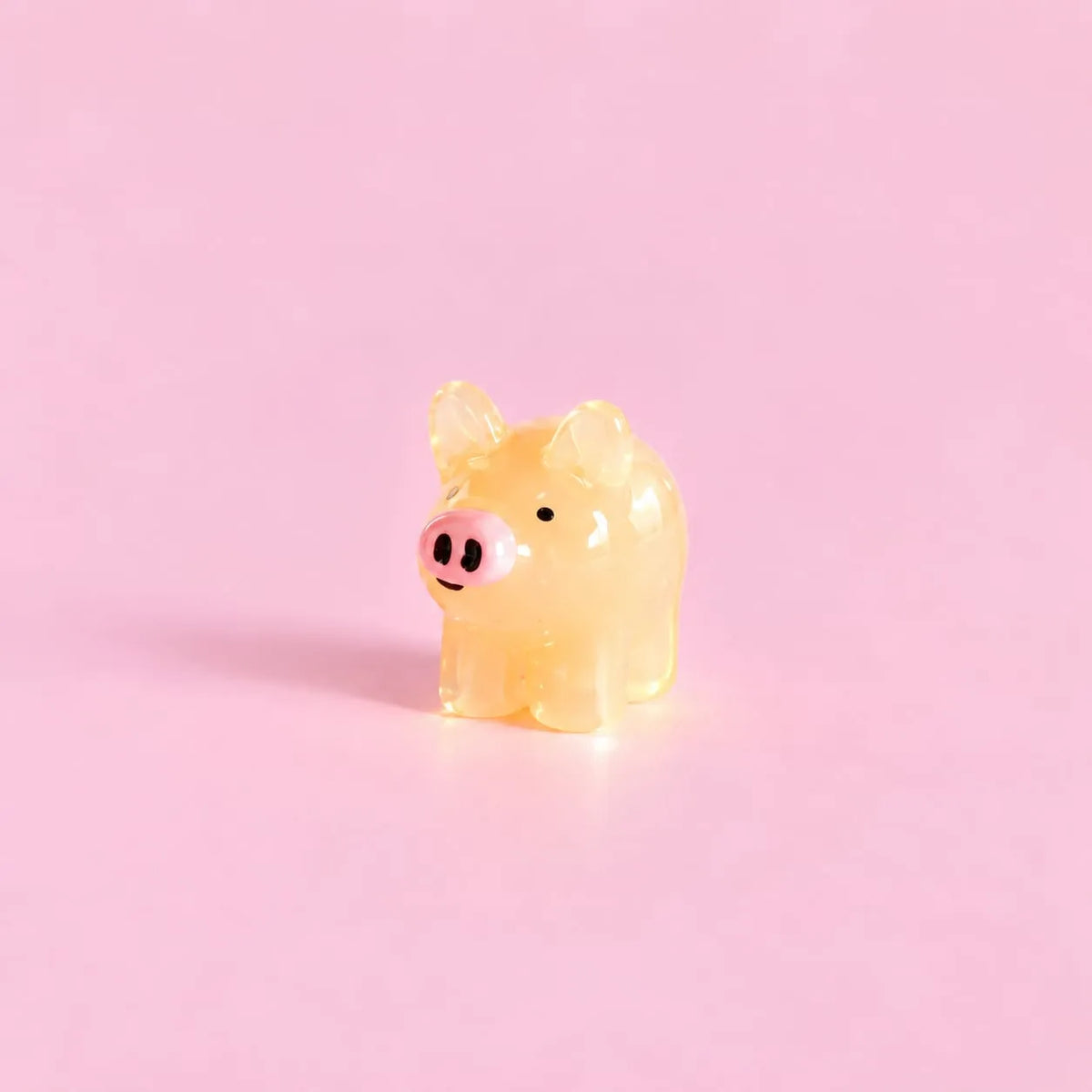Miniature Glow Mini Pig Assorted (1pc) displayed on a pink background