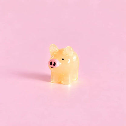 Miniature Glow Mini Pig Assorted (1pc) displayed on a pink background