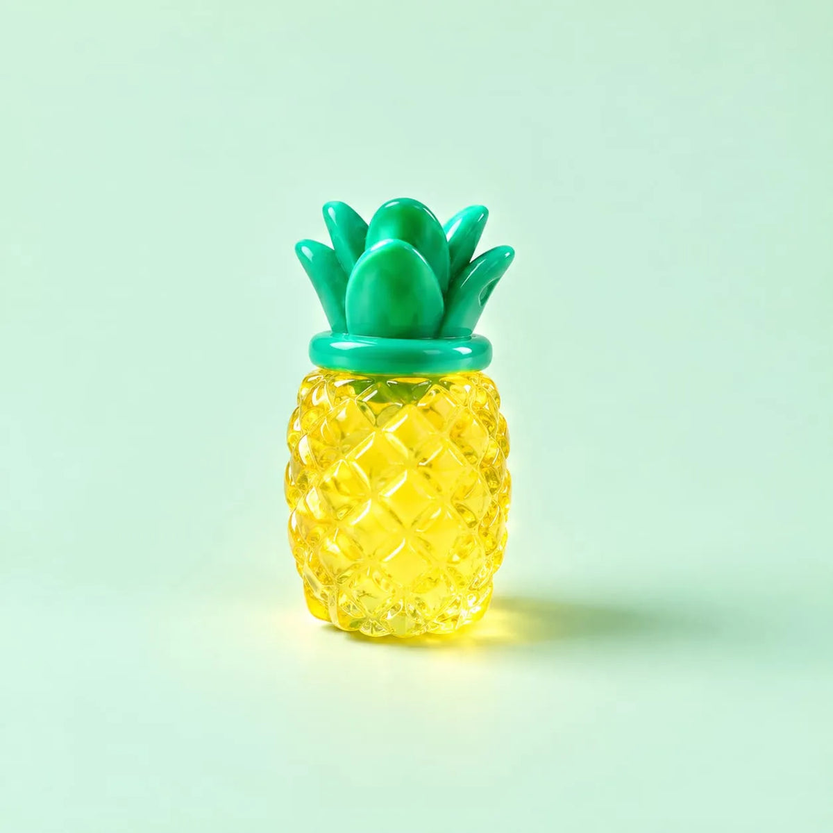 Miniature Glow Pineapple Fruit Assorted (1pc) displayed on a mint green background