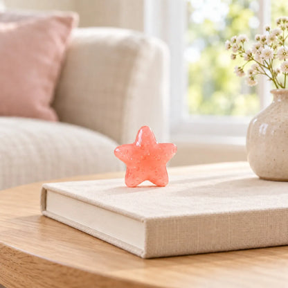 Miniature Glow Starfish Assorted (1pc) displayed on a book near a window