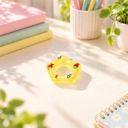 Miniature Glow Floating Swimming Ring Assorted (1pc) displayed on a desk near a window