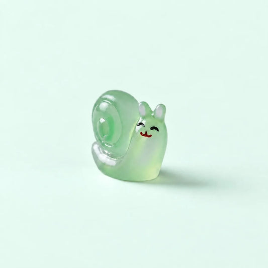 Miniature Glow Snail Assorted (1pc) displayed on a mint green background