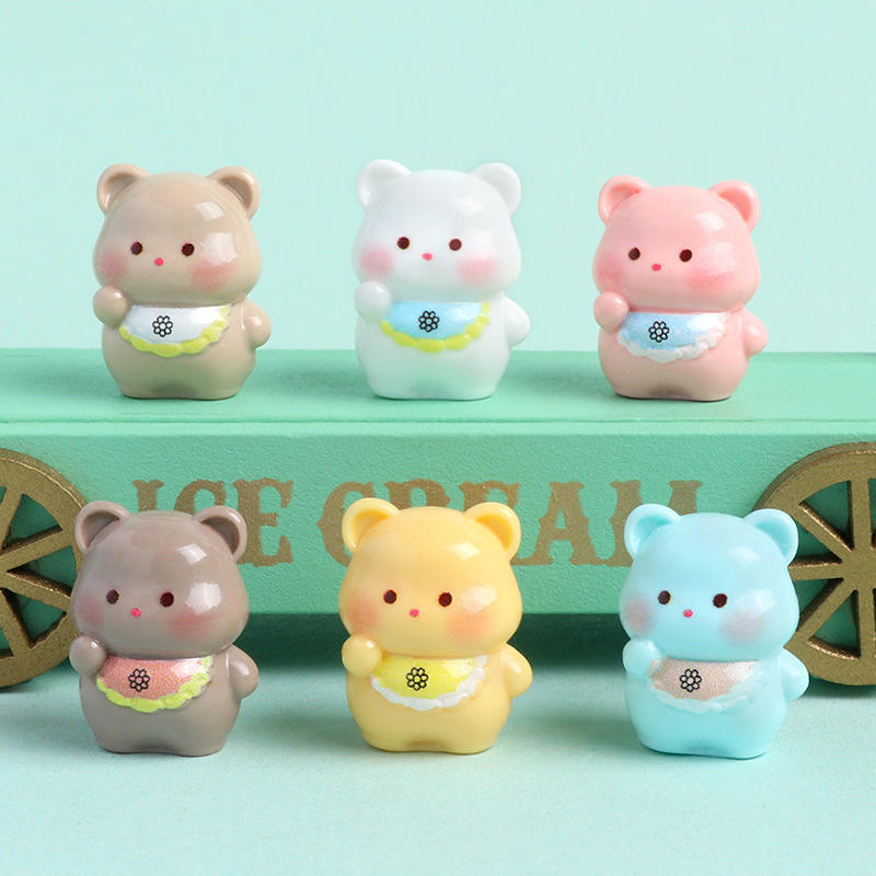 Collection of Miniature Cute Resin Bear on the light greenish background.