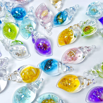 Collection of Miniature Glow Resin Conch Shells in different colours.
