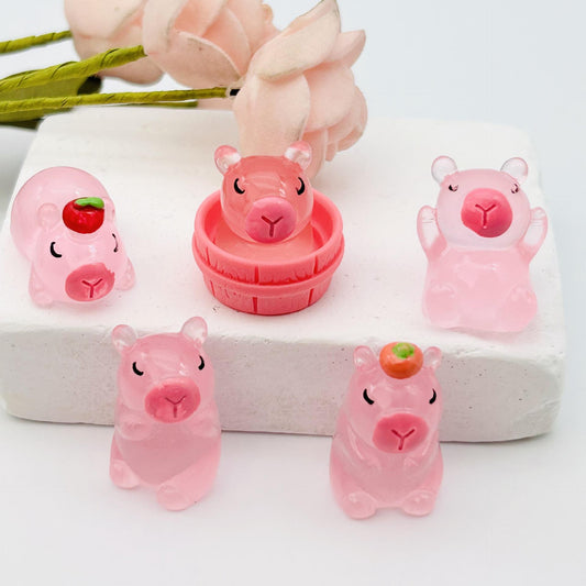 Collection of Miniature Glow Cute Pig with pink roses in the background.